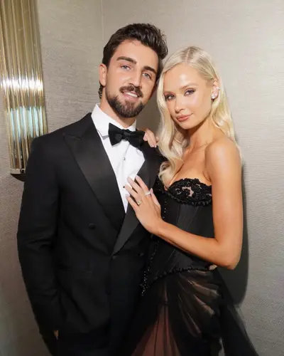 Couple at the Brownlow, she in a black lace gown with platinum hair in soft Hollywood waves